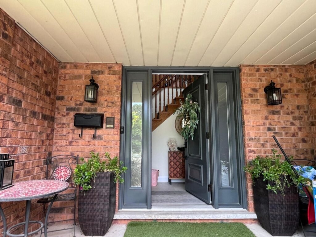 Exterior of a house featuring a brick wall facade, adding a warm and textured architectural detail